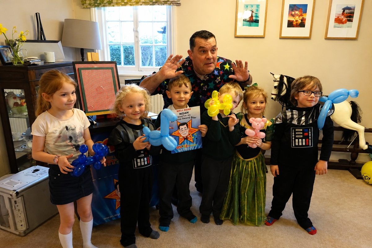 Children holding balloon models at a Marli the Magician party in Kent